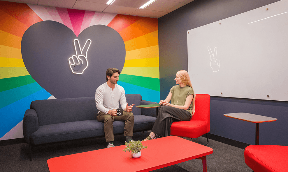 2 SIE Employees chatting in a Sony meeting room.