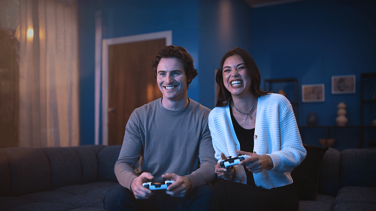 A couple holding gaming controllers