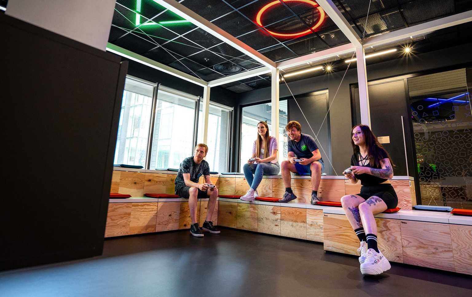 Employees playing games in SIE corporate offices.